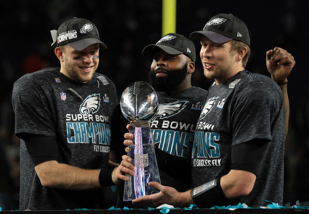 Malcolm Jenkins #27 of the Philadelphia Eagles (C) and Nick Foles #9 (R) of the Philadelphia Eagles hold the Lombardi Trophy