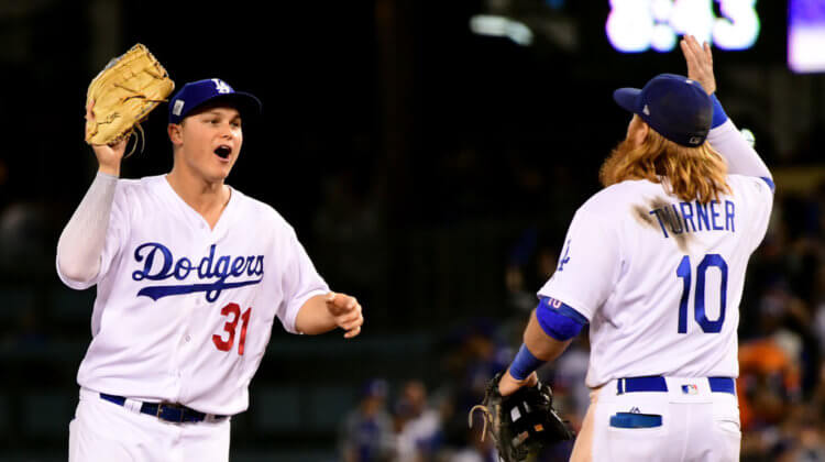 Joc Pederson #31 of the Los Angeles Dodgers celebrates with Justin Turner #10 after defeating the Houston Astros 3-1