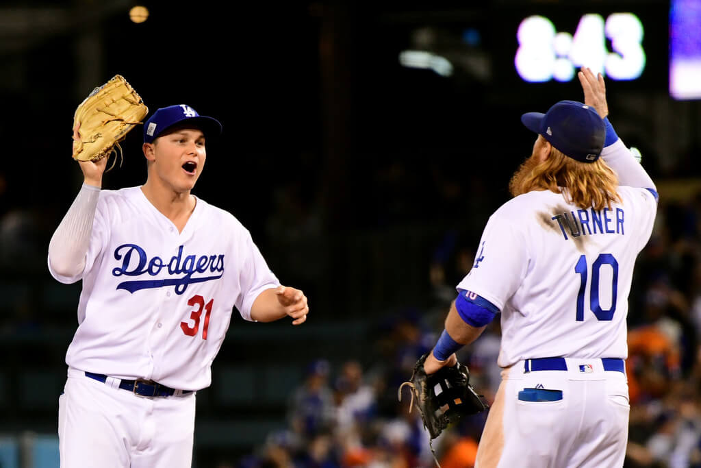 Joc Pederson #31 of the Los Angeles Dodgers celebrates with Justin Turner #10 after defeating the Houston Astros 3-1