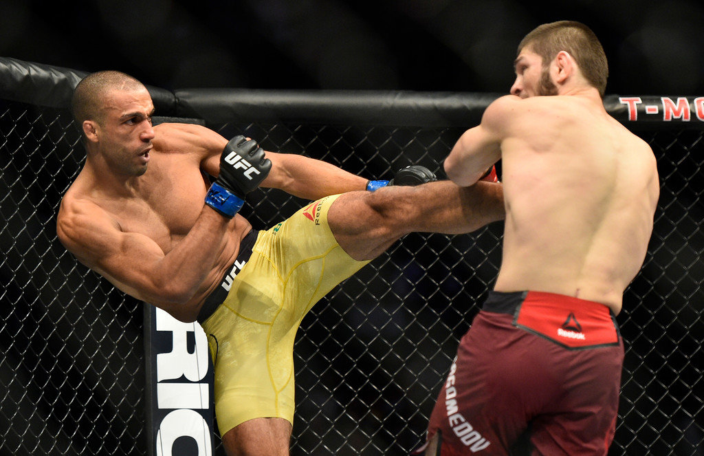 Edson Barboza of Brazil kicks Khabib Nurmagomedov of Russia in their lightweight bout during UFC 219