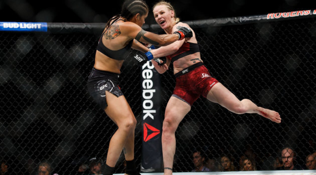 Valentina Shevchenko rips a left kick into the leg of Amanda Nunes at UFC 215