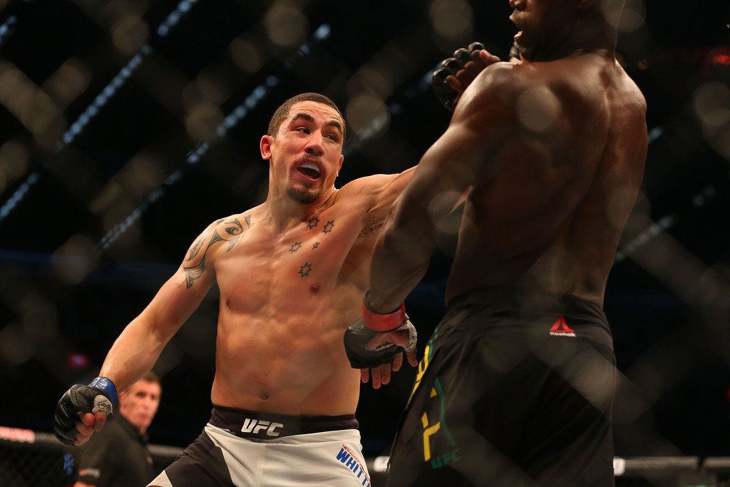 Robert Whittaker of New Zealand (L) and Uriah Hall of Jamaica compete in their middleweight bout during the UFC 193