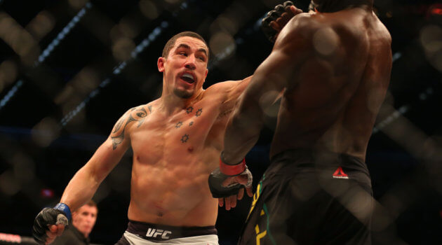 Robert Whittaker of New Zealand (L) and Uriah Hall of Jamaica compete in their middleweight bout during the UFC 193