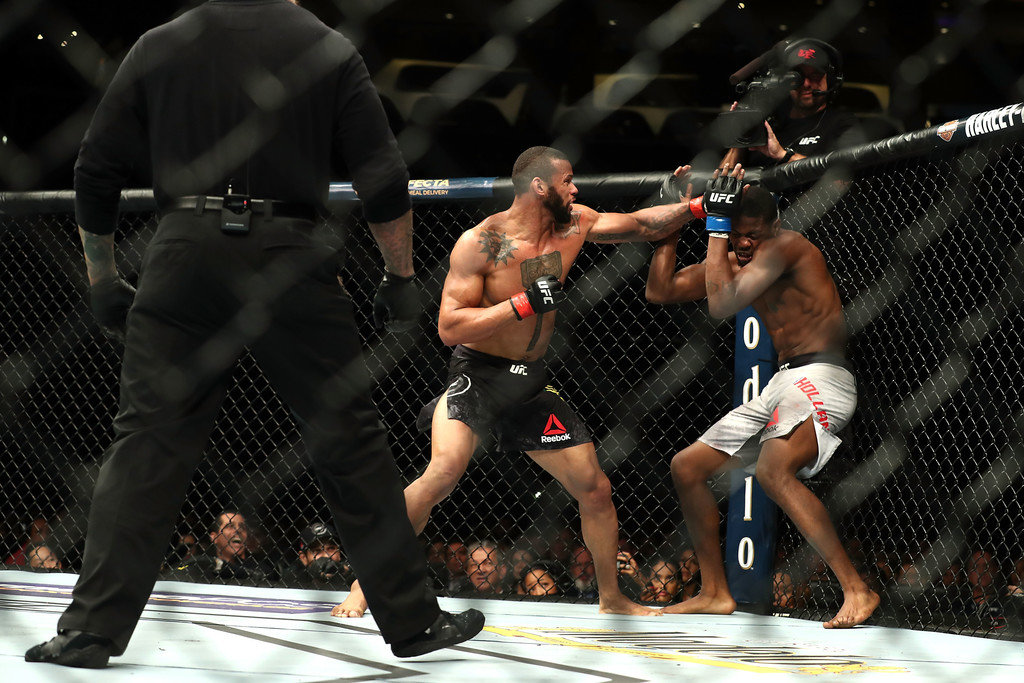 Thiago Santos punches Kevin Holland in the third round in the middleweight bout during UFC 227