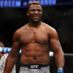 Francis Ngannou walks around the UFC cage after a big win