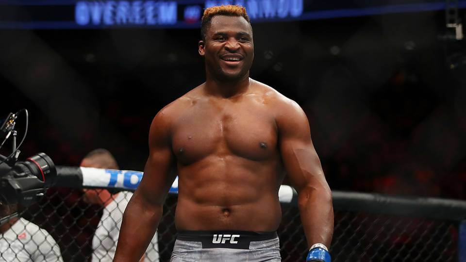 Francis Ngannou walks around the UFC cage after a big win