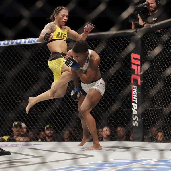 Jessica Andrade of Brazil (yellow) kicks Angela Hill during their women's strawweight bout at UFC Fight Night at the Toyota Center on February 4, 2017 in Houston, Texas. (Feb. 3, 2017 - Source: Tim Warner/Getty Images North America)