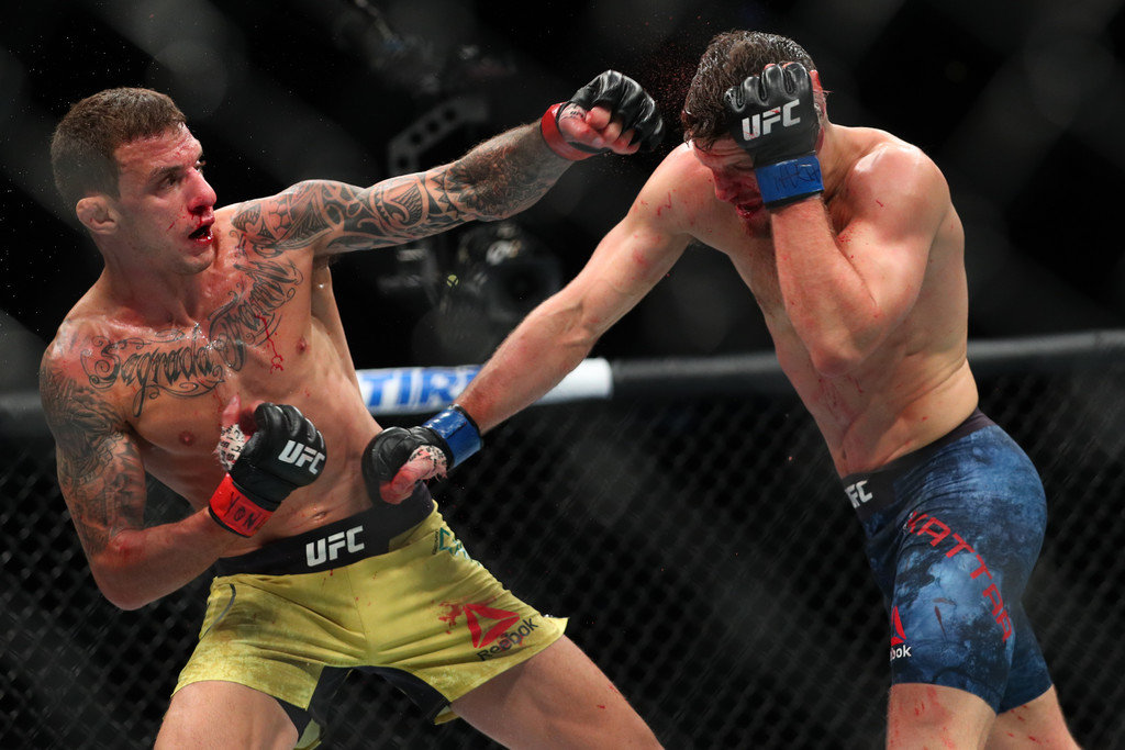 Renato Moicano(L) lands a left hand to the head of Calvin Kattar