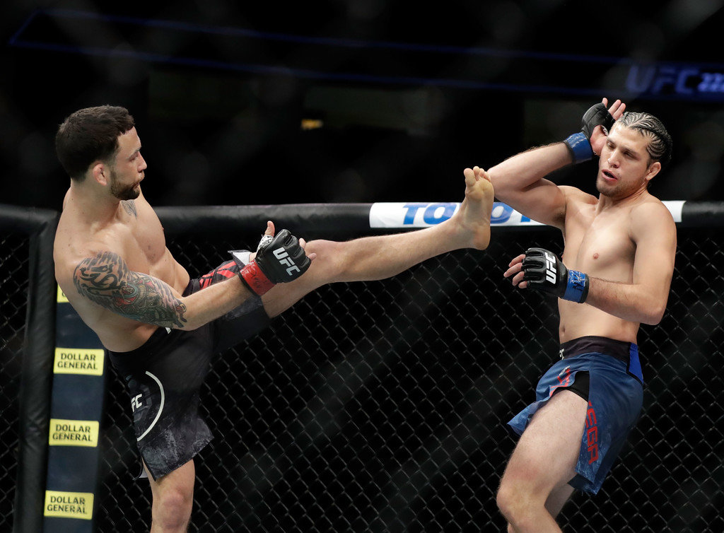 Frankie Edgar (L) and Brian Ortega fight during their featherweight bout during UFC 222