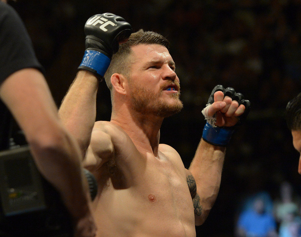Michael Bisping raises his hands after fighting Luke Rockhold