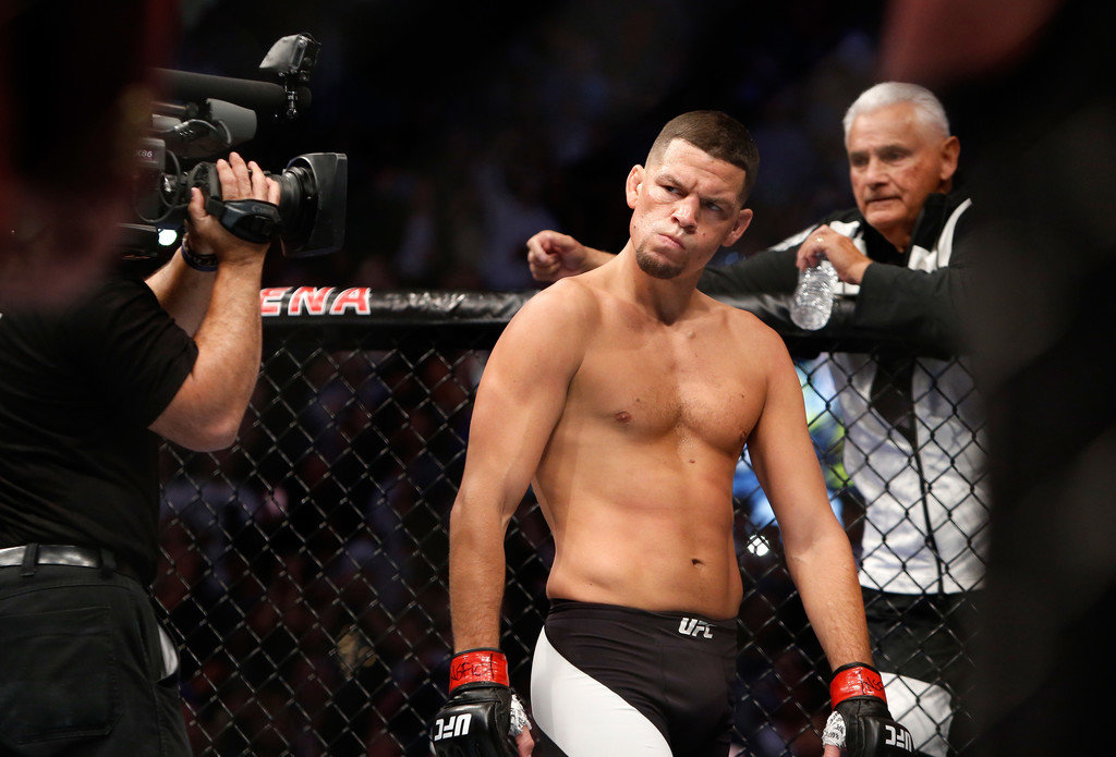 Nate Diaz eyes Conor McGregor from across the Octagon before their welterweight rematch
