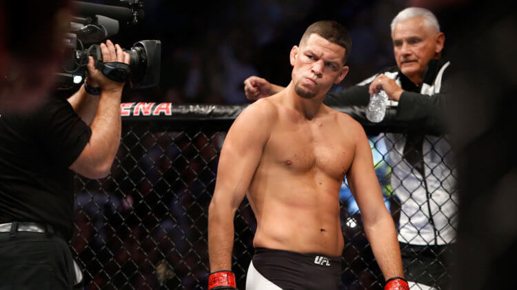 Nate Diaz eyes Conor McGregor from across the Octagon before their welterweight rematch