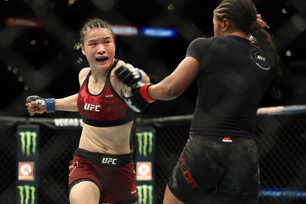 Weili Zhang punches Danielle Taylor in the second round of the women's featherweight bout during UFC 227